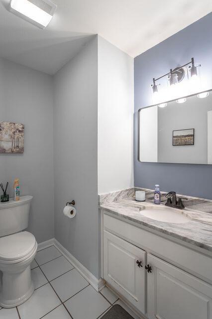 8424 Shadetree Ln, Ooltewah, TN 37363 - half bath with toilet, tile patterned flooring, vanity, and baseboards