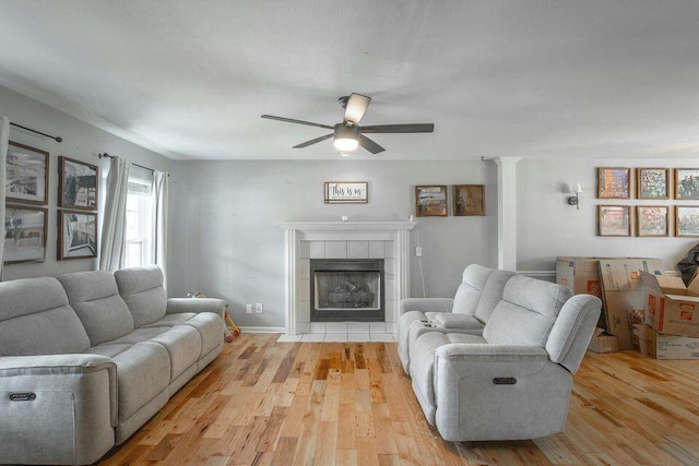 8424 Shadetree Ln, Ooltewah, TN 37363 - living area with ceiling fan, light wood-style flooring, and a tiled fireplace