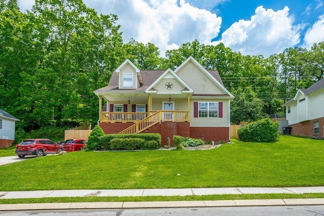 8424 Shadetree Ln, Ooltewah, TN 37363 - view of front of house with covered porch, stairway, a front lawn, and brick siding
