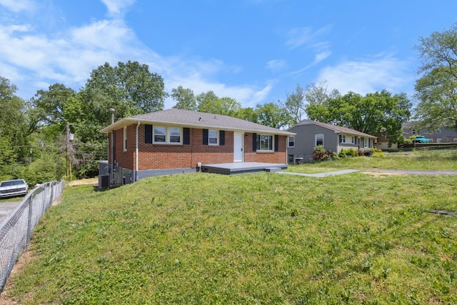 ranch-style home with fence, a front yard, and brick siding