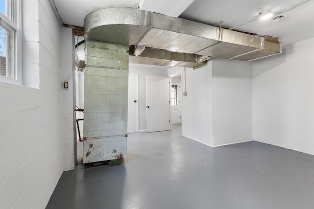below grade area featuring concrete block wall