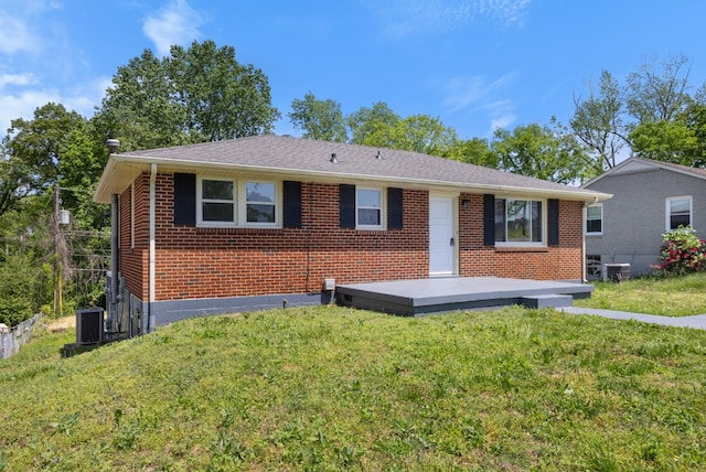 ranch-style home with a deck, a front lawn, and brick siding