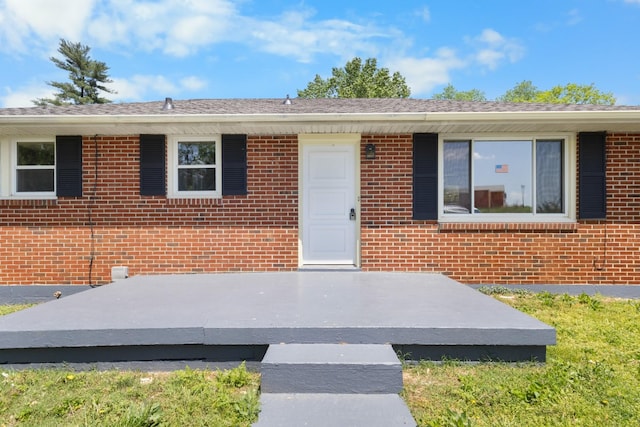 entrance to property with brick siding