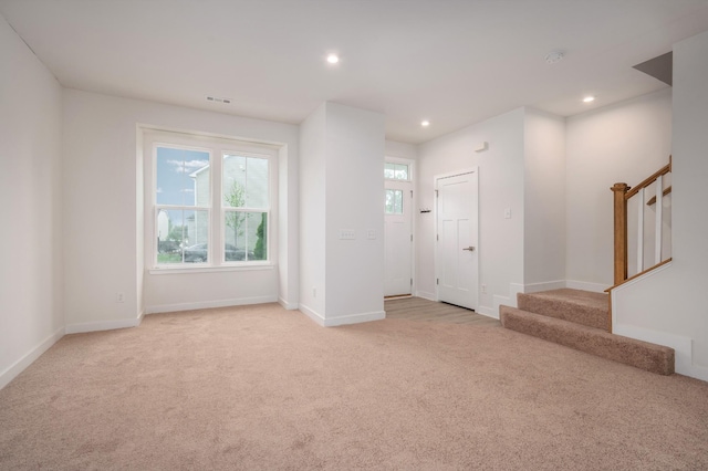 entryway with light colored carpet, visible vents, baseboards, recessed lighting, and stairs