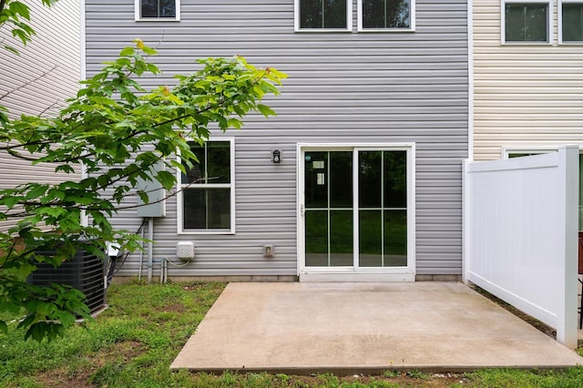 entrance to property featuring central AC unit and a patio area