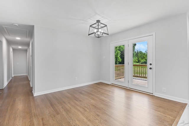 466 Lafayette Rd, Clarksville, TN 37042 - unfurnished dining area featuring baseboards, attic access, wood finished floors, and a chandelier