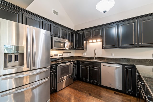 1041 Irish Way, Spring Hill, TN 37174 - kitchen with a sink, stainless steel appliances, dark cabinetry, visible vents, and vaulted ceiling