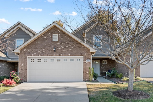 1041 Irish Way, Spring Hill, TN 37174 - traditional-style house featuring driveway, an attached garage, and brick siding
