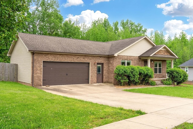 view of front of home with an attached garage, concrete driveway, a front yard, and brick siding