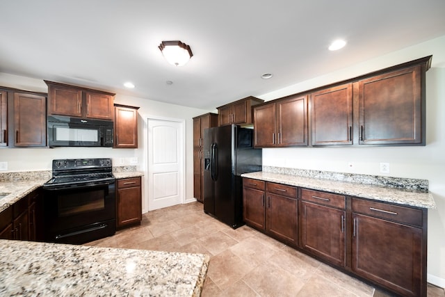 kitchen featuring light stone counters, dark brown cabinetry, black appliances, and recessed lighting