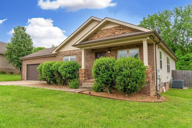 view of front of home with an attached garage, a front lawn, brick siding, central AC unit, and concrete driveway