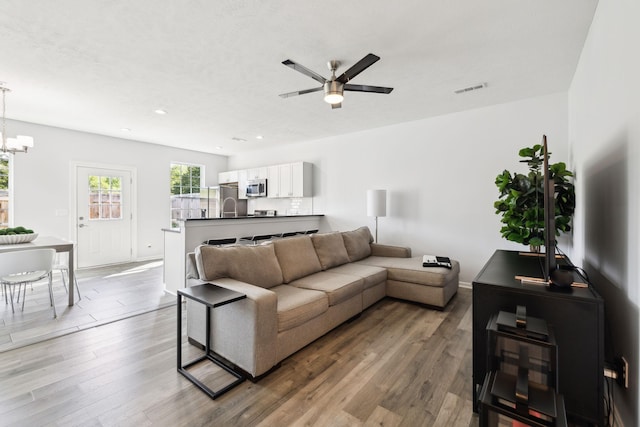 605 Longfellow Ln, Smyrna, TN 37167 - living area with recessed lighting, wood finished floors, ceiling fan with notable chandelier, baseboards, and visible vents