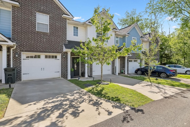 605 Longfellow Ln, Smyrna, TN 37167 - townhome / multi-family property featuring concrete driveway, brick siding, and a garage