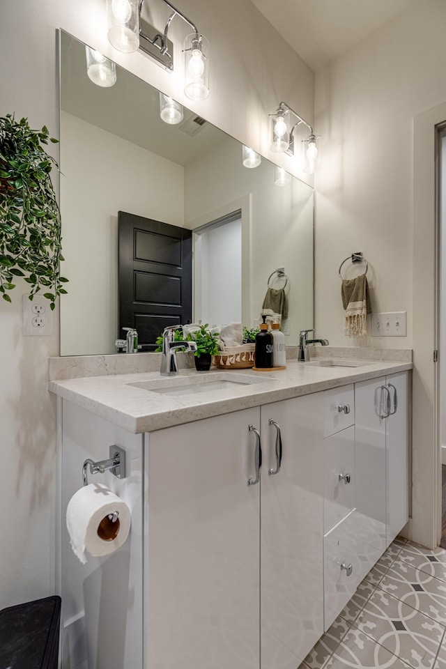 full bathroom featuring tile patterned flooring, double vanity, and a sink