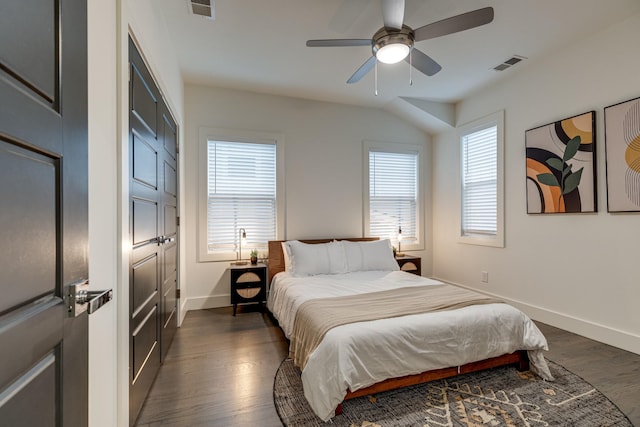 bedroom with baseboards, visible vents, ceiling fan, and dark wood-type flooring