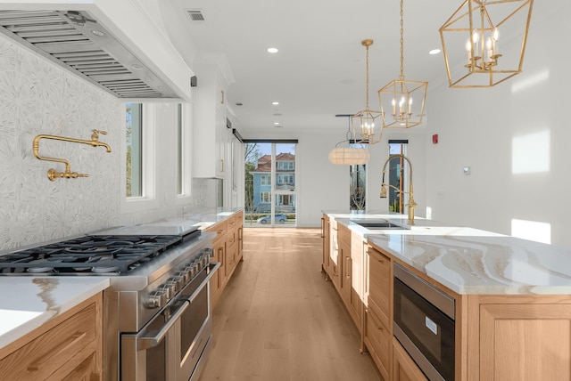 95 Leonard Ave Unit 1, Nashville, TN 37205 - kitchen featuring stainless steel appliances, range hood, a sink, light brown cabinetry, and light wood-style floors