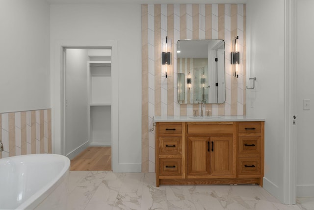 95 Leonard Ave Unit 1, Nashville, TN 37205 - full bath with marble look tiles, a freestanding tub, vanity, and baseboards
