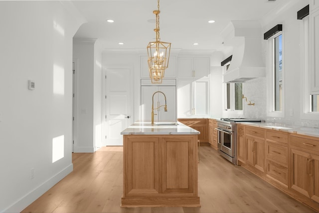 95 Leonard Ave Unit 1, Nashville, TN 37205 - kitchen featuring high quality appliances, a sink, light wood-type flooring, light countertops, and a center island with sink