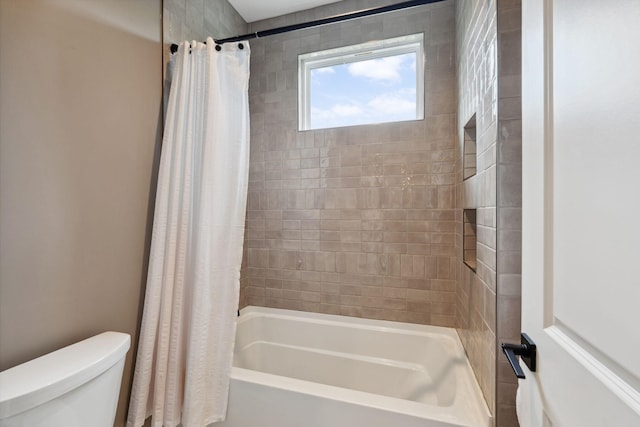 full bathroom featuring shower / bath combo and toilet