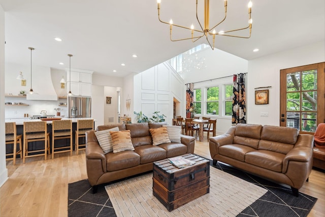 living room featuring an inviting chandelier, recessed lighting, and light wood-style flooring