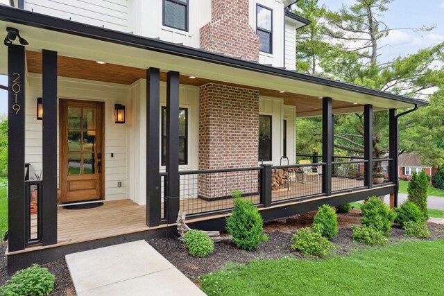 view of exterior entry with a porch