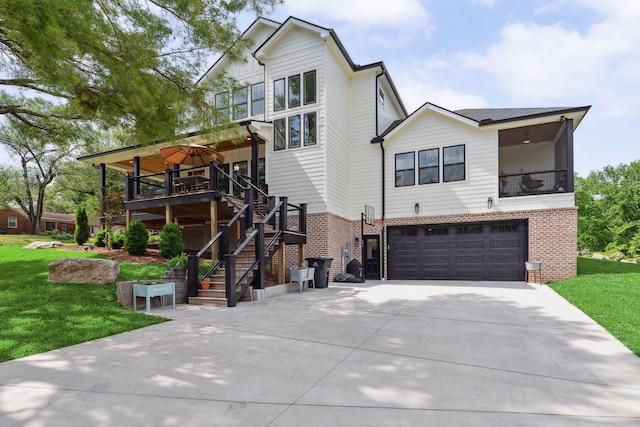 view of front of property with driveway, a front yard, a garage, stairway, and brick siding