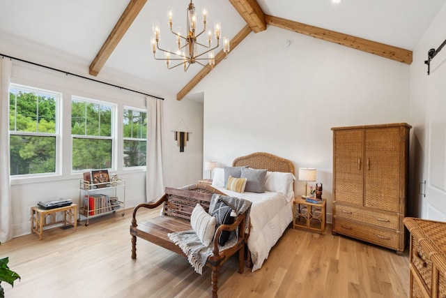 bedroom with light wood-type flooring, a barn door, a notable chandelier, and beamed ceiling