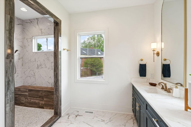 bathroom with vanity, visible vents, marble finish floor, baseboards, and a marble finish shower