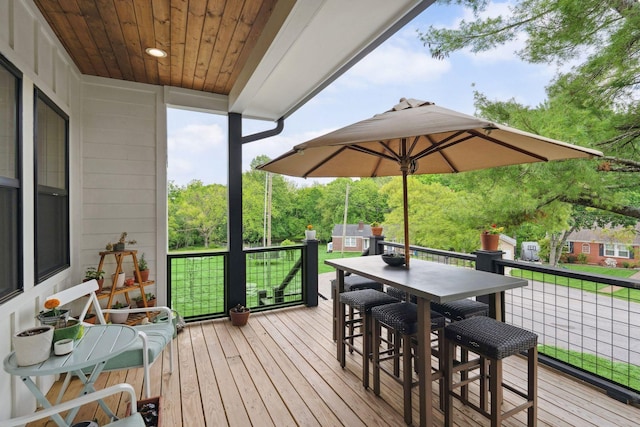 wooden terrace featuring outdoor dining space