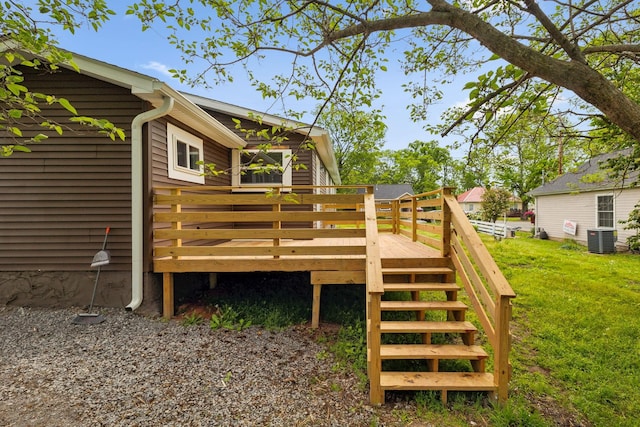 wooden deck featuring a lawn, stairs, and central air condition unit
