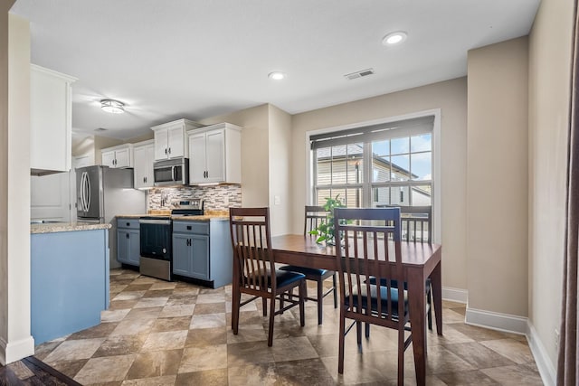 1277 Morstead Dr, Clarksville, TN 37042 - dining area featuring stone finish flooring, recessed lighting, visible vents, and baseboards