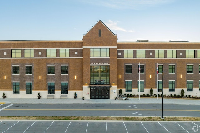 view of building exterior featuring uncovered parking