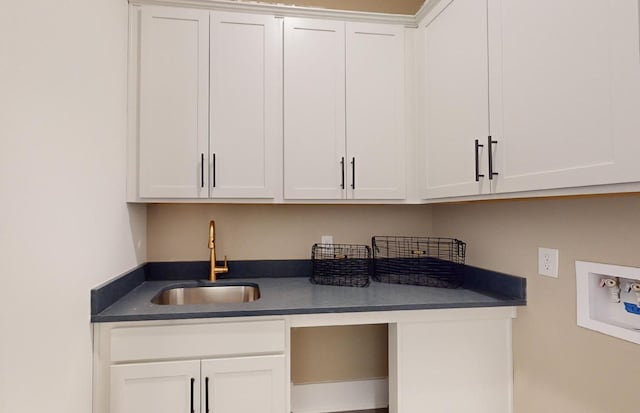 washroom featuring cabinet space, a sink, and washer hookup