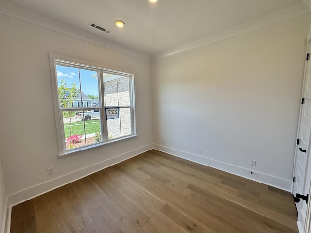 unfurnished room with recessed lighting, crown molding, visible vents, baseboards, and wood finished floors