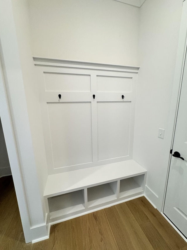 mudroom featuring dark wood finished floors and baseboards