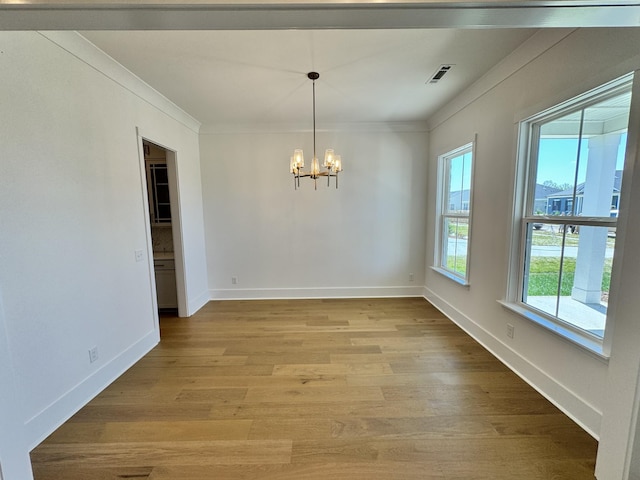 unfurnished dining area with a chandelier, light wood-type flooring, and visible vents