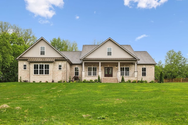 8020 Traditions Ln, Columbia, TN 38401 - view of front facade featuring a standing seam roof, fence, a front lawn, and brick siding