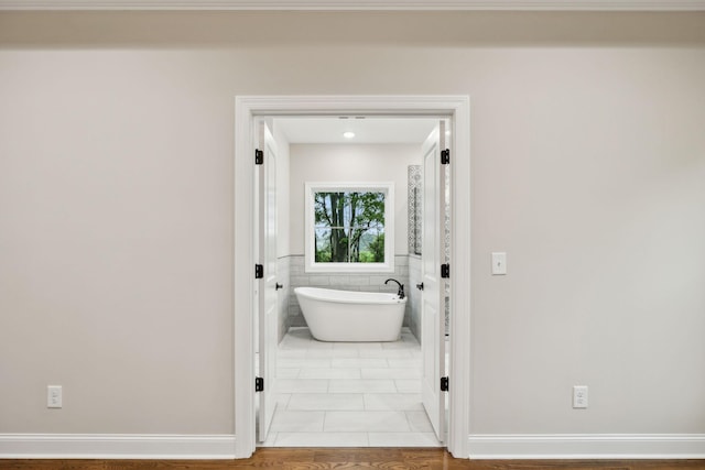 8020 Traditions Ln, Columbia, TN 38401 - bathroom featuring tile walls, a freestanding bath, and tile patterned flooring