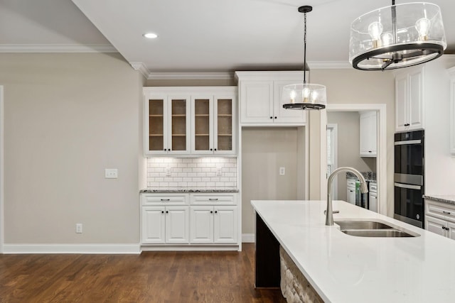 8020 Traditions Ln, Columbia, TN 38401 - kitchen with glass insert cabinets, a sink, a notable chandelier, multiple ovens, and crown molding