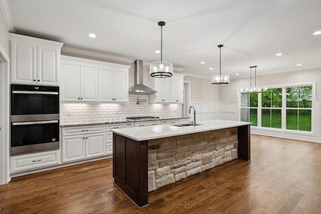 8020 Traditions Ln, Columbia, TN 38401 - kitchen featuring appliances with stainless steel finishes, a sink, an inviting chandelier, and wall chimney exhaust hood