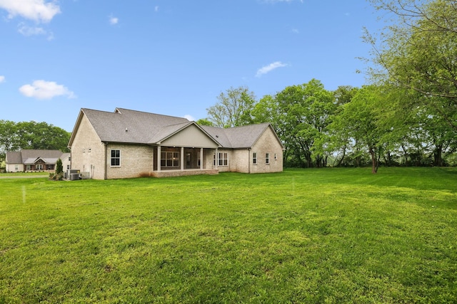 8020 Traditions Ln, Columbia, TN 38401 - back of house featuring a sunroom, a yard, and central air condition unit
