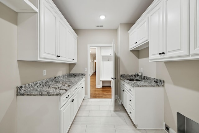 8020 Traditions Ln, Columbia, TN 38401 - kitchen with white cabinetry, visible vents, light stone countertops, and a sink