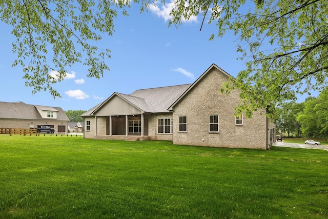 8020 Traditions Ln, Columbia, TN 38401 - rear view of property featuring a yard, brick siding, and a sunroom