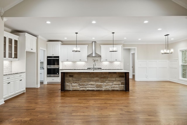 8020 Traditions Ln, Columbia, TN 38401 - kitchen featuring tasteful backsplash, stainless steel double oven, wall chimney exhaust hood, and dark wood-style flooring