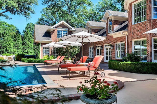 exterior space featuring a patio, french doors, and brick siding