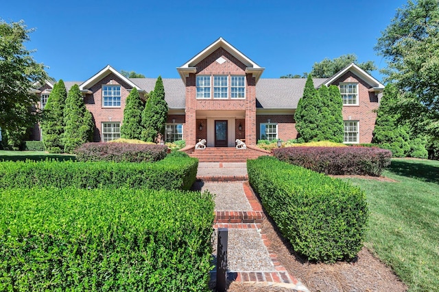 view of front facade featuring a front lawn and brick siding