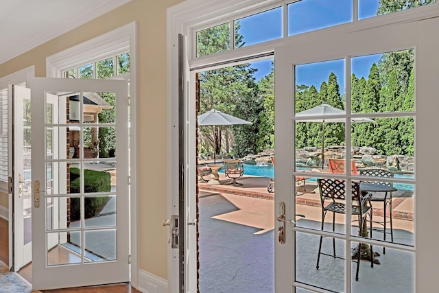 entryway featuring a wealth of natural light, french doors, and crown molding