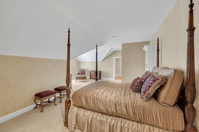bedroom with baseboards, light colored carpet, and vaulted ceiling