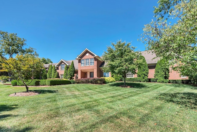 view of front of house featuring a front yard and brick siding