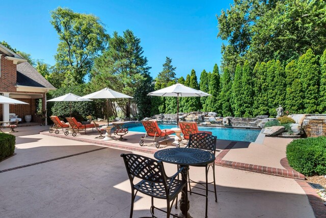 outdoor pool with a patio area